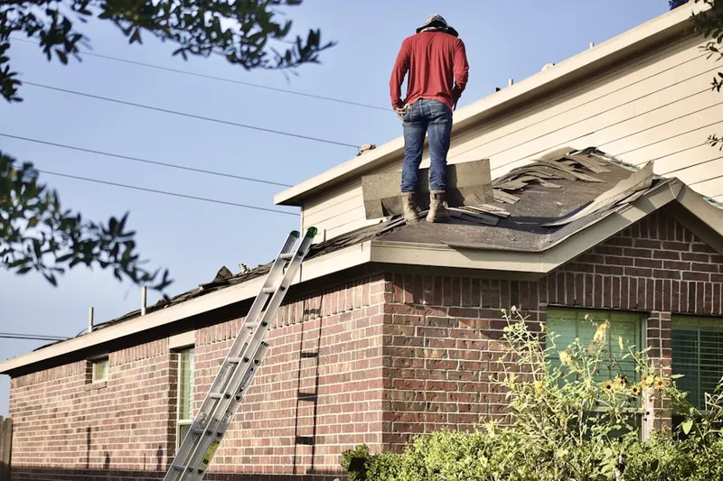 Professional roofer working on a residential roof in Hidden Lake